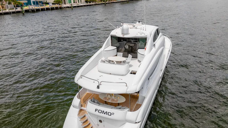 Slide: The Image of Luxury 2002 Lazzara 80 Skylounge yacht on water, featuring spacious deck and sleek design. - 8