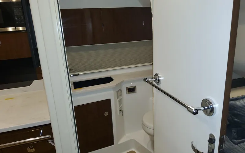 Slide: The Image of 2022 Formula 400 Super Sport Crossover bathroom interior with modern fixtures and wood accents. - 11