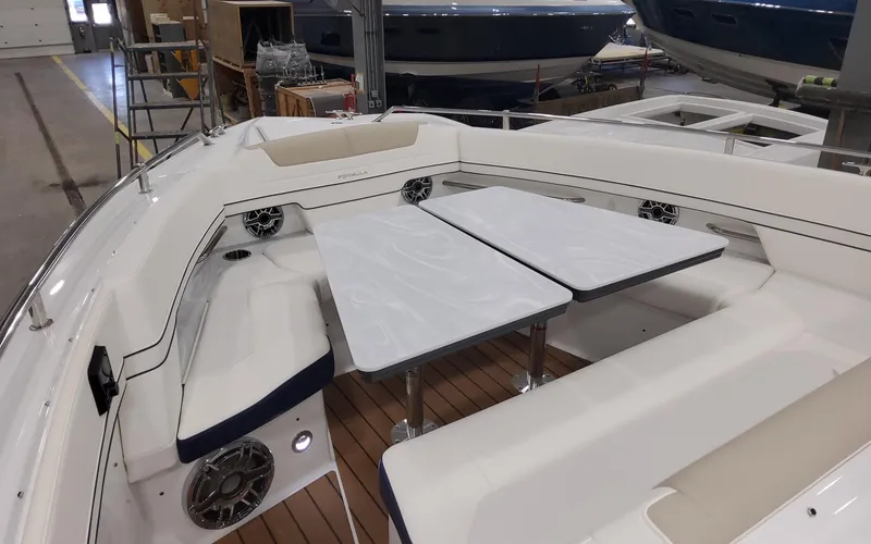 Slide: The Image of 2022 Formula 400 Super Sport Crossover boat interior with seating and tables. - 14