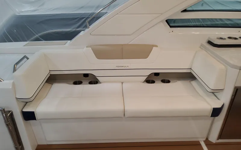 Slide: The Image of 2022 Formula 400 Super Sport Crossover boat interior with white seating and cup holders. - 16