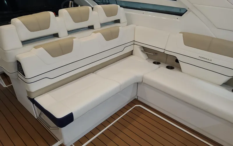 Slide: The Image of 2022 Formula 400 Super Sport Crossover boat interior with luxurious seating and teak flooring. - 17