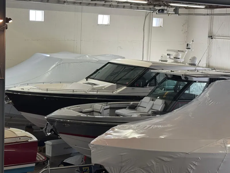 Slide: The Image of 2022 Formula 400 Super Sport Crossover boats stored indoors, partially covered. - 3