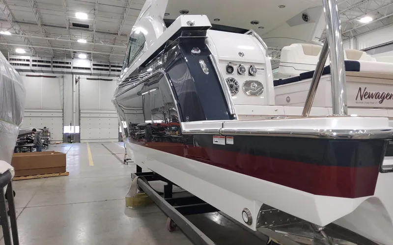 Slide: The Image of 2022 Formula 400 Super Sport Crossover boat in a spacious indoor facility. - 4