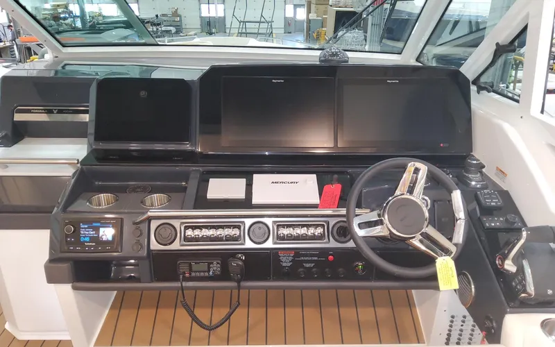 Slide: The Image of 2022 Formula 400 Super Sport Crossover helm with modern controls and navigation screens. - 8