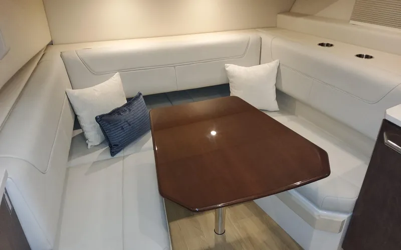 Slide: The Image of 2022 Formula 400 Super Sport Crossover interior with elegant seating and wooden table. - 9