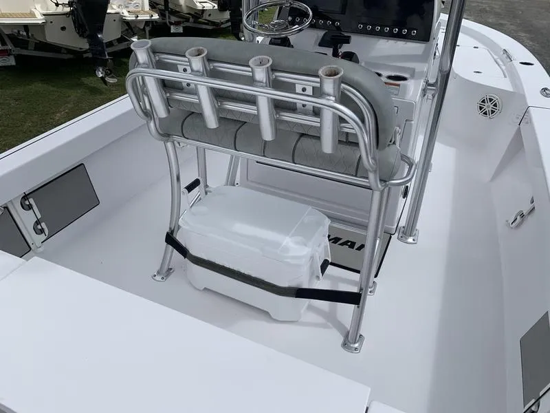 Slide: The Image of 2020 Sportsman Masters 227 boat interior with rod holders and cooler. - 14