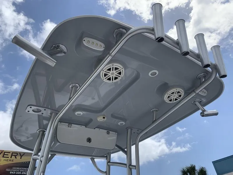 Slide: The Image of 2020 Sportsman Masters 227 T-top with rod holders and speakers against a blue sky. - 17