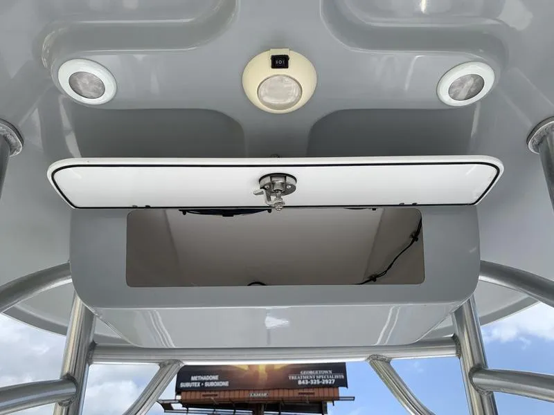 Slide: The Image of 2020 Sportsman Masters 227 boat console with open storage compartment and overhead lights. - 18