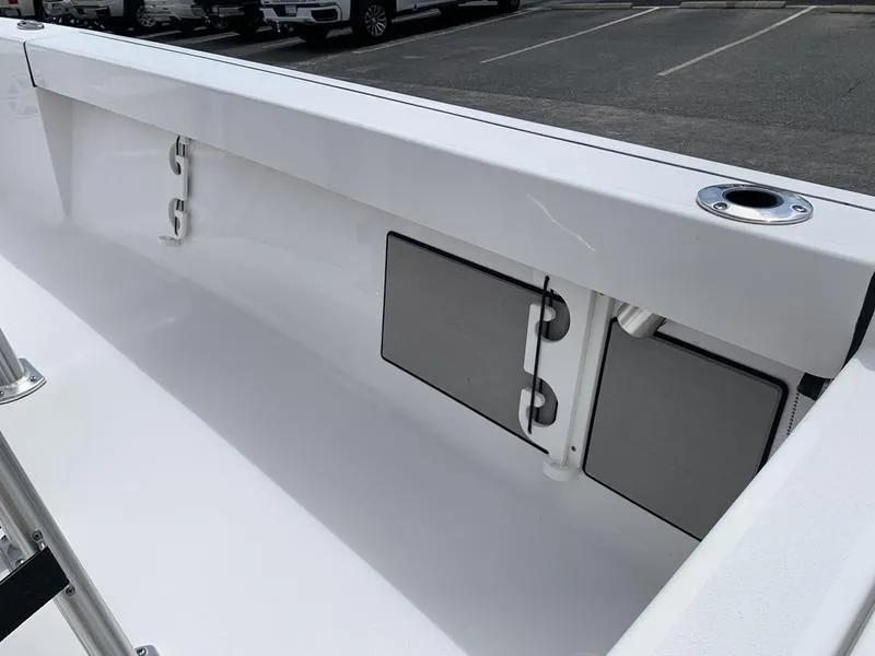 Slide: The Image of 2020 Sportsman Masters 227 boat interior with storage compartments and rod holders. - 22