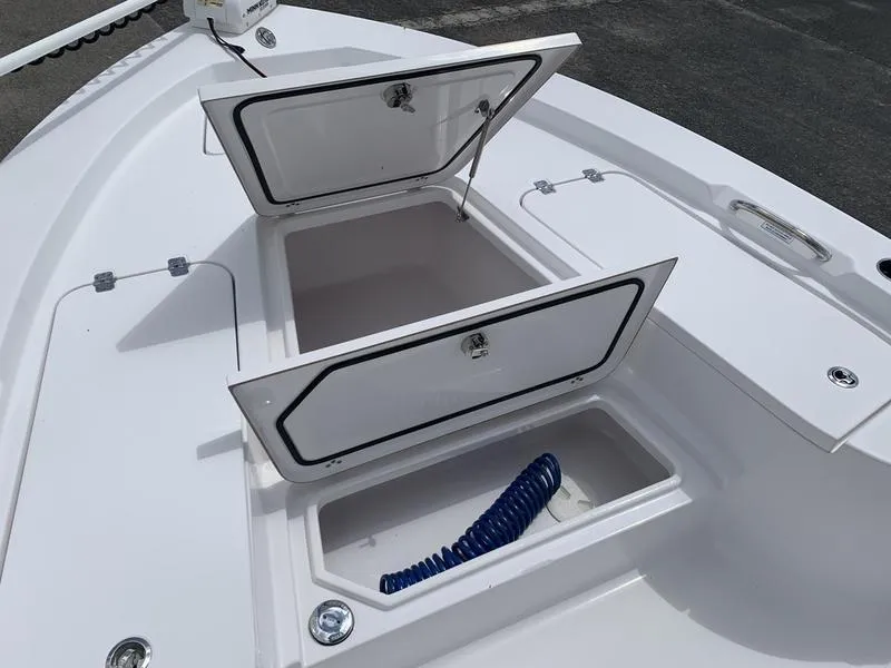 Slide: The Image of 2020 Sportsman Masters 227 boat with open storage compartments on deck. - 28