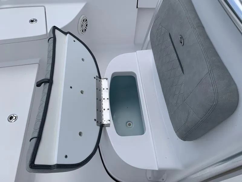 Slide: The Image of 2020 Sportsman Masters 227 boat with open storage compartment and cushioned seating. - 31