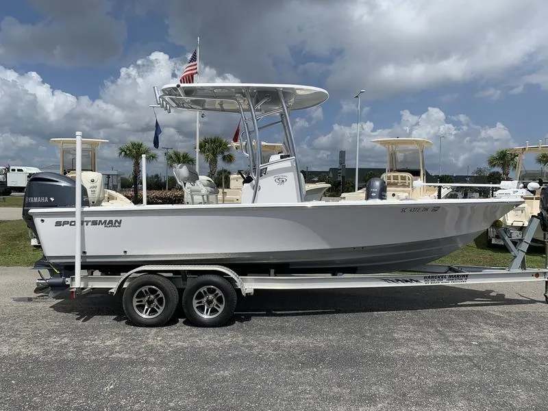 Slide: The Image of 2020 Sportsman Masters 227 boat on trailer, parked outdoors under cloudy sky. - 5