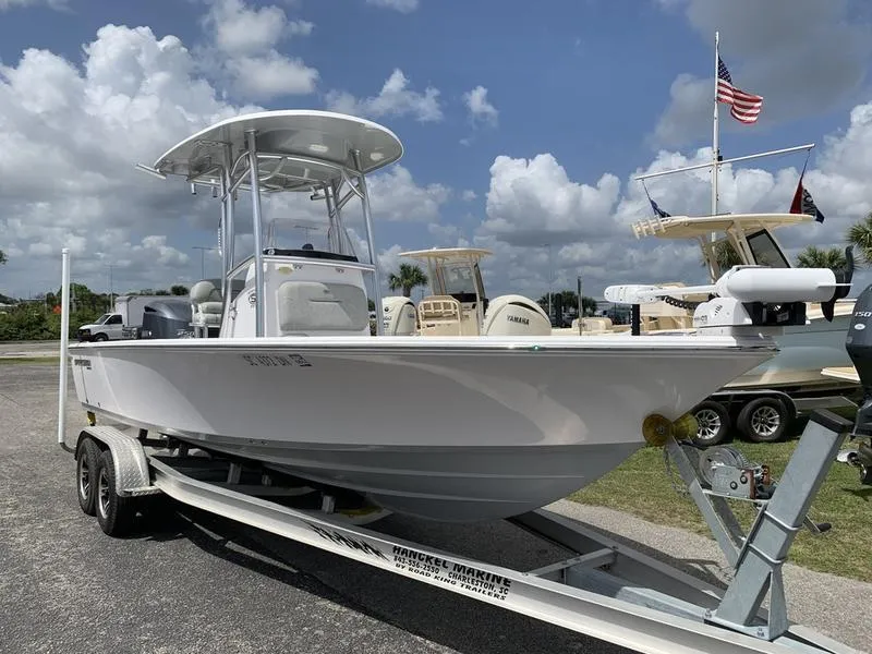 Slide: The Image of 2020 Sportsman Masters 227 boat on trailer, parked outdoors under cloudy sky. - 6