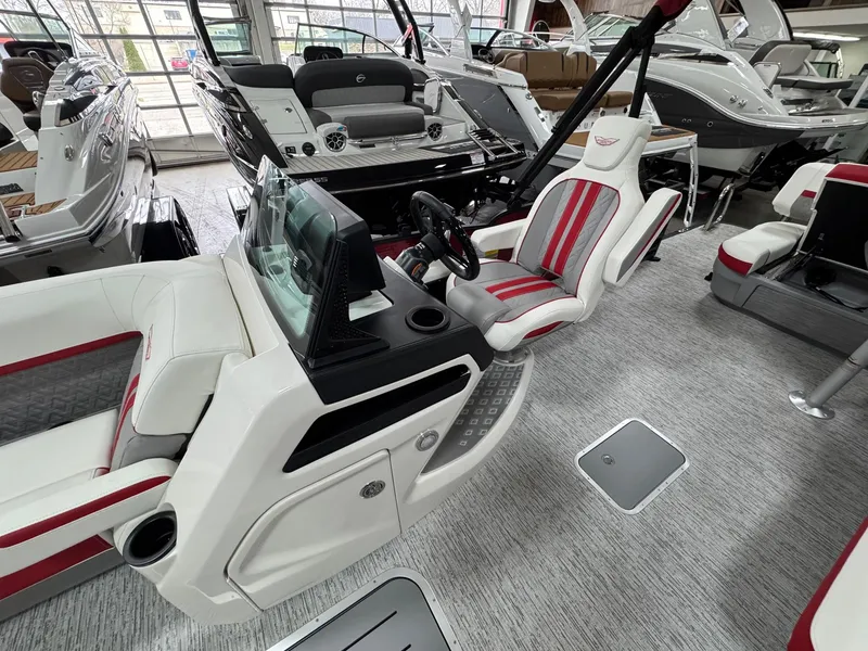 Slide: The Image of 2025 Bennington 24 ML boat interior with modern helm and red-accented seating. - 15