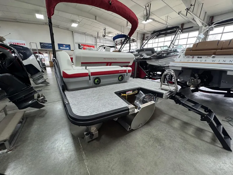 Slide: The Image of 2025 Bennington 24 ML pontoon boat in showroom, featuring sleek design and modern amenities. - 16