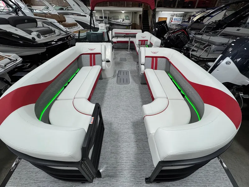 Slide: The Image of 2025 Bennington 24 ML pontoon boat interior with red and white seating, green LED accents. - 4