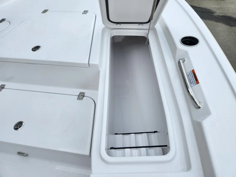 Slide: The Image of 2025 Sportsman Masters 247 Bay Boat storage compartment with open hatch, showcasing spacious interior. - 10