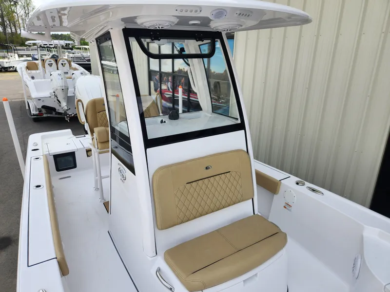 Slide: The Image of 2025 Sportsman Masters 247 Bay Boat with tan seating and modern console design. - 12