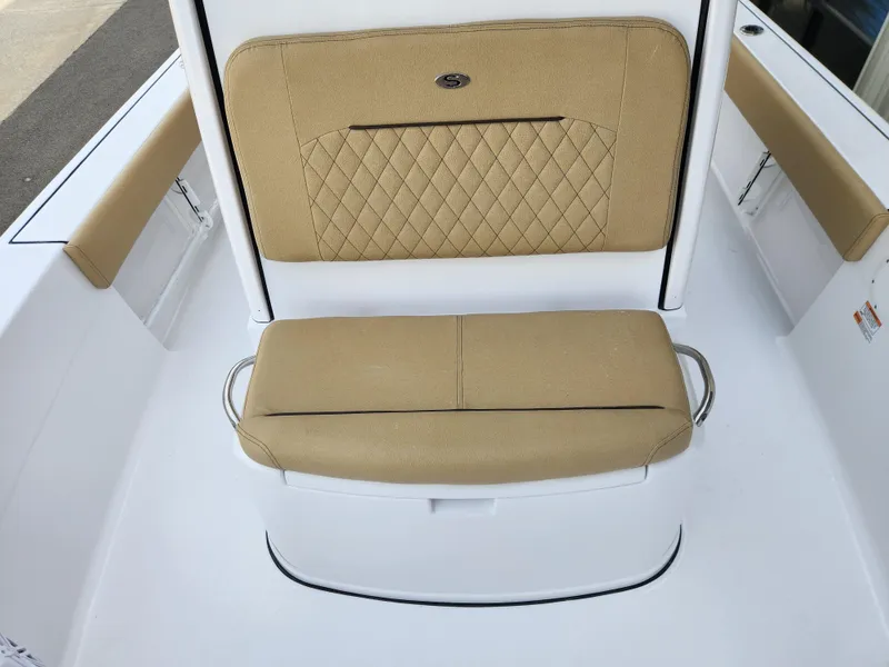 Slide: The Image of 2025 Sportsman Masters 247 Bay Boat seating with tan cushions and diamond stitching. - 13