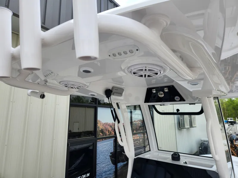 Slide: The Image of 2025 Sportsman Masters 247 Bay Boat interior with speakers and rod holders. - 19