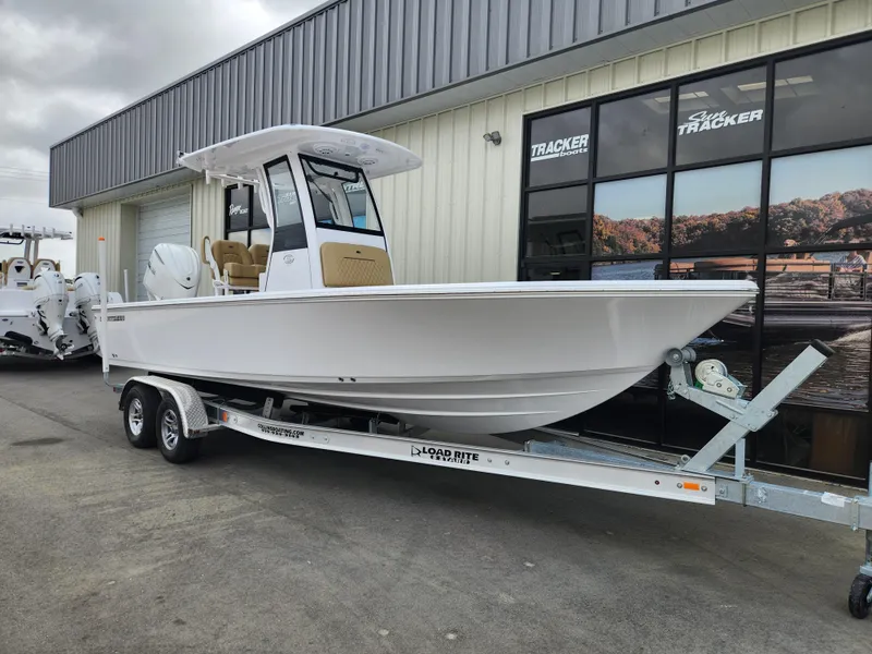 Slide: The Image of 2025 Sportsman Masters 247 Bay Boat on trailer, parked outside a building. - 2