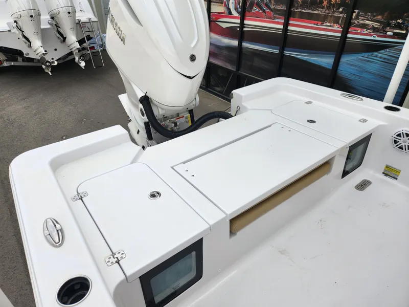 Slide: The Image of 2025 Sportsman Masters 247 Bay Boat, rear deck view with engine and storage compartments. - 22