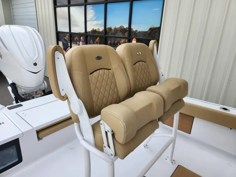 Slide: The Image of 2025 Sportsman Masters 247 Bay Boat with tan cushioned seating and white frame. - 28