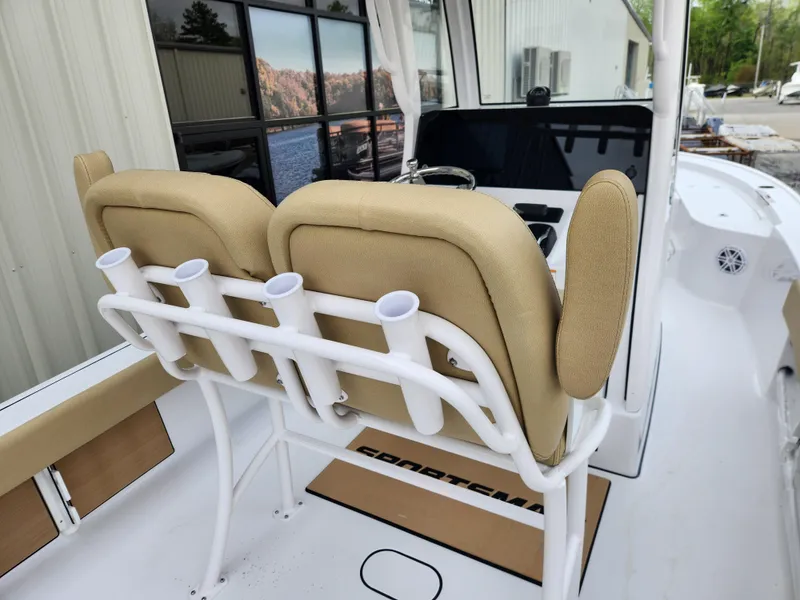 Slide: The Image of 2025 Sportsman Masters 247 Bay Boat interior with beige seating and rod holders. - 29