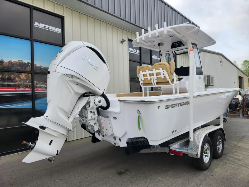 Slide: The Image of 2025 Sportsman Masters 247 Bay Boat on trailer, featuring powerful outboard motor. - 4