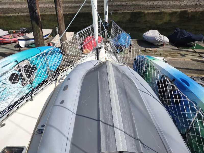 Slide: The Image of Deck of 1988 Cascade 42 sailboat with kayaks and netting. - 15
