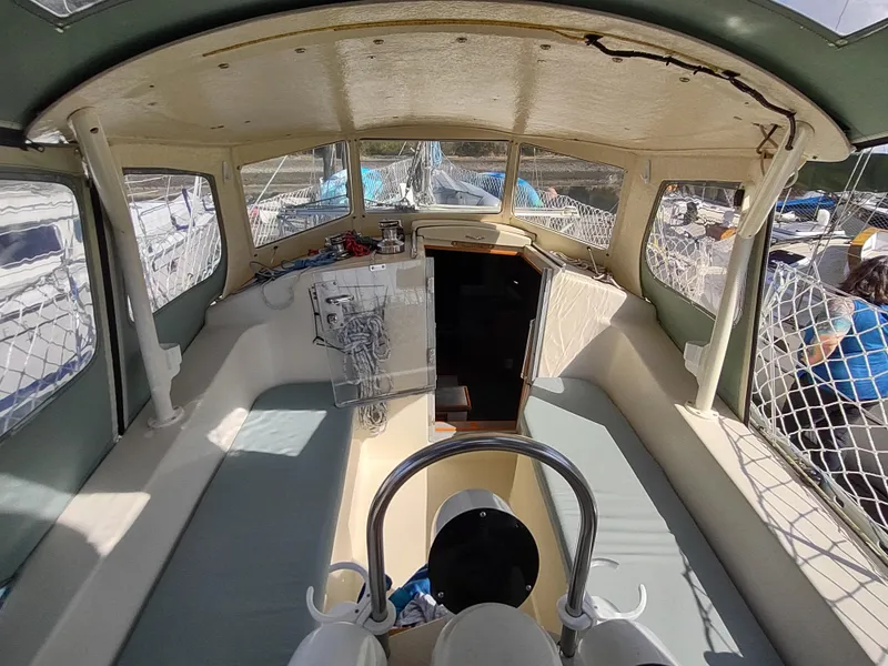 Slide: The Image of 1988 Cascade 42 sailboat cockpit with helm, seating, and cabin entrance. - 29