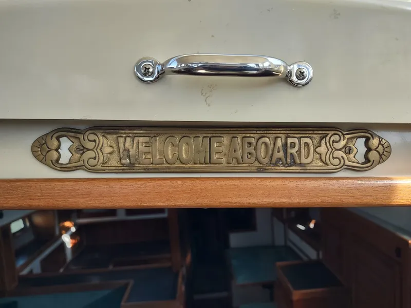 Slide: The Image of "Welcome Aboard" sign on 1988 Cascade 42 boat interior. - 33
