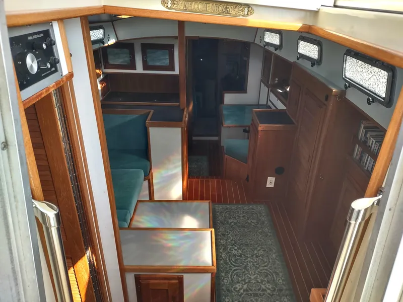 Slide: The Image of Interior of 1988 Cascade 42 sailboat with wood paneling and teal seating. - 34