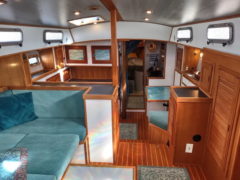Slide: The Image of Interior of 1988 Cascade 42 sailboat with wood finish and teal seating. - 35