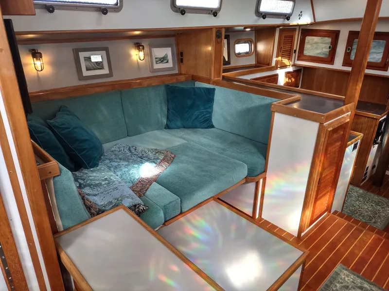 Slide: The Image of Cozy interior of 1988 Cascade 42 yacht with teal seating and wooden accents. - 36