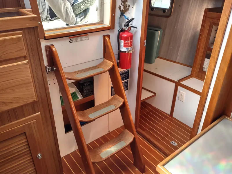 Slide: The Image of Interior of 1988 Cascade 42 boat with wooden steps and fire extinguisher. - 39