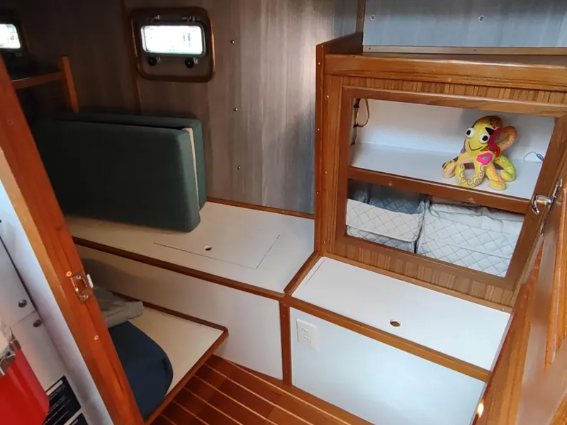 Slide: The Image of Cozy cabin interior of 1988 Cascade 42 sailboat with wooden shelves and plush toy. - 40