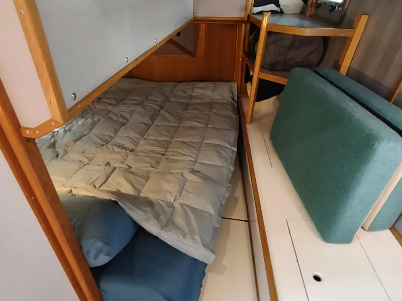 Slide: The Image of Cozy sleeping area in 1988 Cascade 42 boat with bunk beds and cushions. - 41