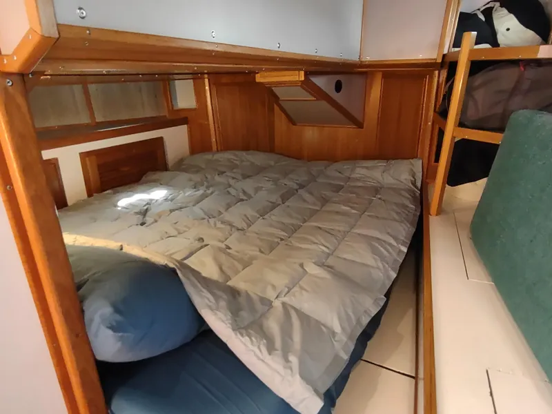 Slide: The Image of Cozy cabin interior of 1988 Cascade 42 sailboat with wooden accents and comfortable bedding. - 42