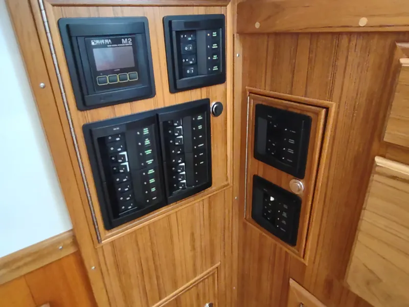 Slide: The Image of Electrical control panel on 1988 Cascade 42 boat with wooden interior. - 43