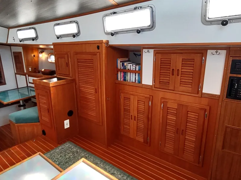 Slide: The Image of Interior of 1988 Cascade 42 sailboat with wooden cabinets and cozy seating area. - 44