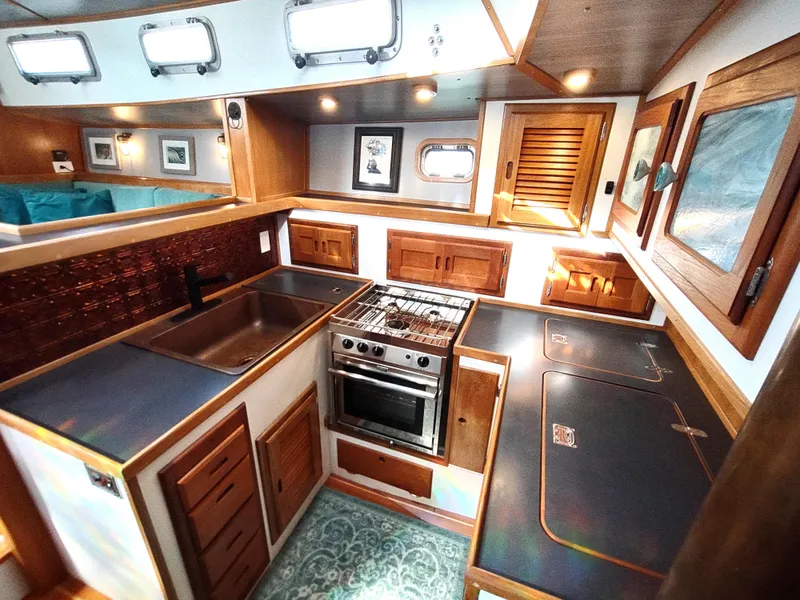 Slide: The Image of 1988 Cascade 42 yacht kitchen with wood cabinetry, stainless steel appliances, and ample counter space. - 46