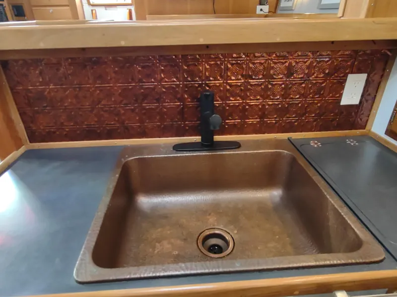 Slide: The Image of Rustic kitchen sink with copper backsplash, Cascade 42 model, 1988 design. - 47