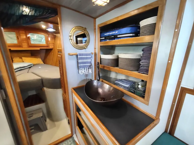 Slide: The Image of Interior of 1988 Cascade 42 sailboat with cozy cabin and stylish sink area. - 49