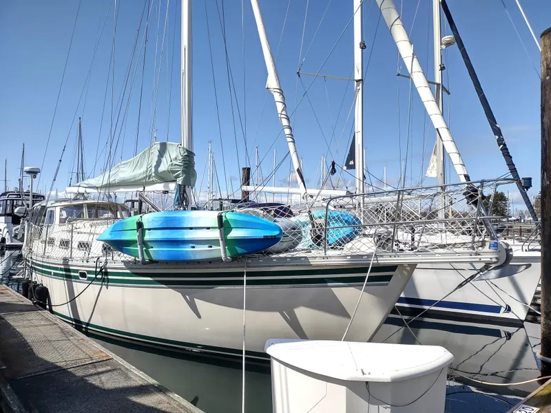 Slide: The Image of Sailboat Cascade 42, 1988 model, docked with blue kayaks on deck. - 6