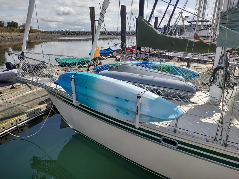 Slide: The Image of Sailboat docked with kayaks, Cascade 42 model, 1988, in a marina setting. - 8