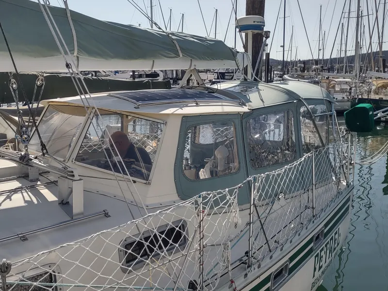 Slide: The Image of Sailboat in marina, Cascade 42 model, 1988, with protective netting and covered cockpit. - 9