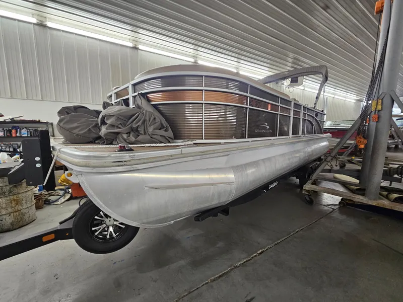Slide: The Image of 2018 Bennington SX25 pontoon boat in a garage, side view. - 1