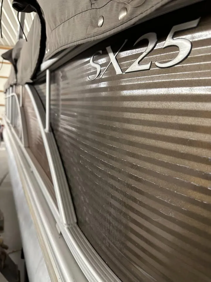 Slide: The Image of 2018 Bennington SX25 boat side view with model name visible. - 10