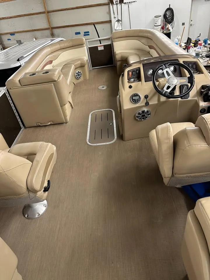 Slide: The Image of 2018 Bennington SX25 boat interior with beige seating and steering console. - 12